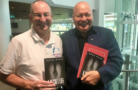 Greg Ryan holiding his new book, A Secret Life.